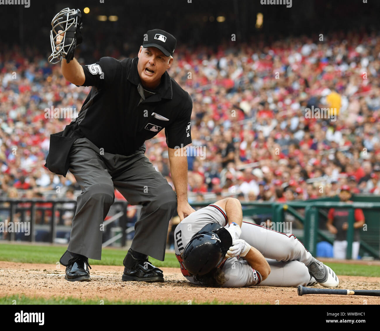 Home Plate Umpire Tim Timmons yells for help after Atlanta Braves Charlie Culberson lies on the ground after being hit by a pitch while trying to bunt by Washington Nationals Fernando Rodney in the seventh inning of game at Nationals Park in Washington, DC on Saturday, September 14, 2019. Culberson left the game.    Photo by Pat Benic/UPI Credit: UPI/Alamy Live News Stock Photo