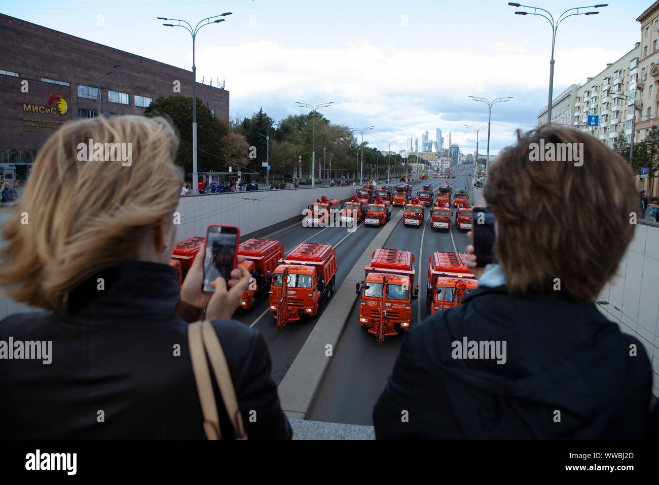 Moscow, Russia. 14th Sep, 2019. People take pictures of a parade of municipal service vehicles in central Moscow, Russia, on Sept. 14, 2019. About 700 vehicles took part in the Municipal Service Vehicle Parade on Saturday. Credit: Alexander Zemlianichenko Jr/Xinhua Stock Photo