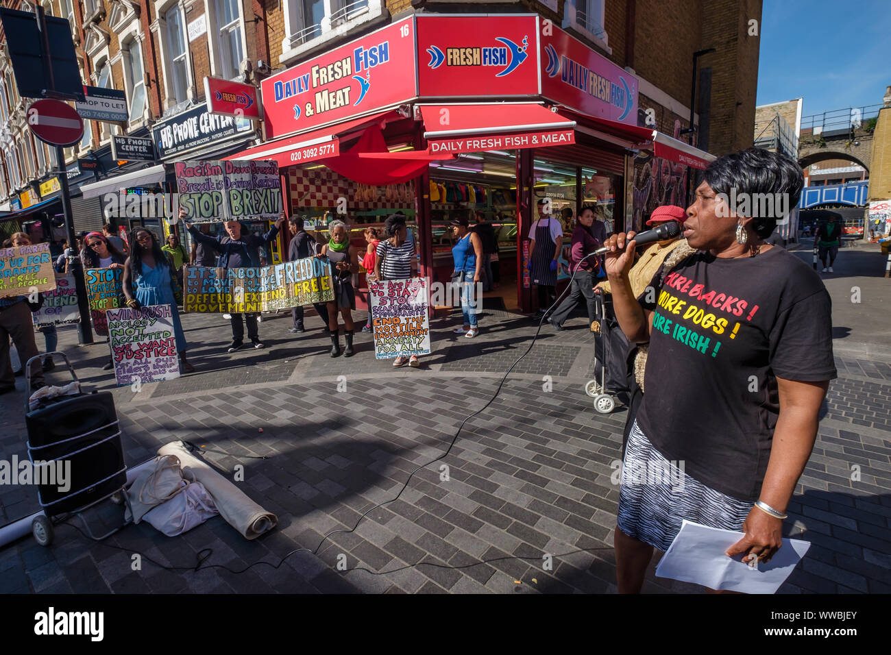 London, UK. 14th September 2019. Eulalee who has been fighting the Home Office for 16 years speaks at the Movement for Justice and Lambeth Unison Black Workers' Group protest in Brixton Market against the continuing persecution of Windrush family members and other migrants, calling for freedom of movement, the closure of immigration detention prisons, and an end to Brexit which is being used to whip up immigrant-bashing and nationalism to establish a Trump-style regime in Britain under Boris Johnson. Peter Marshall/Alamy Live News Stock Photo