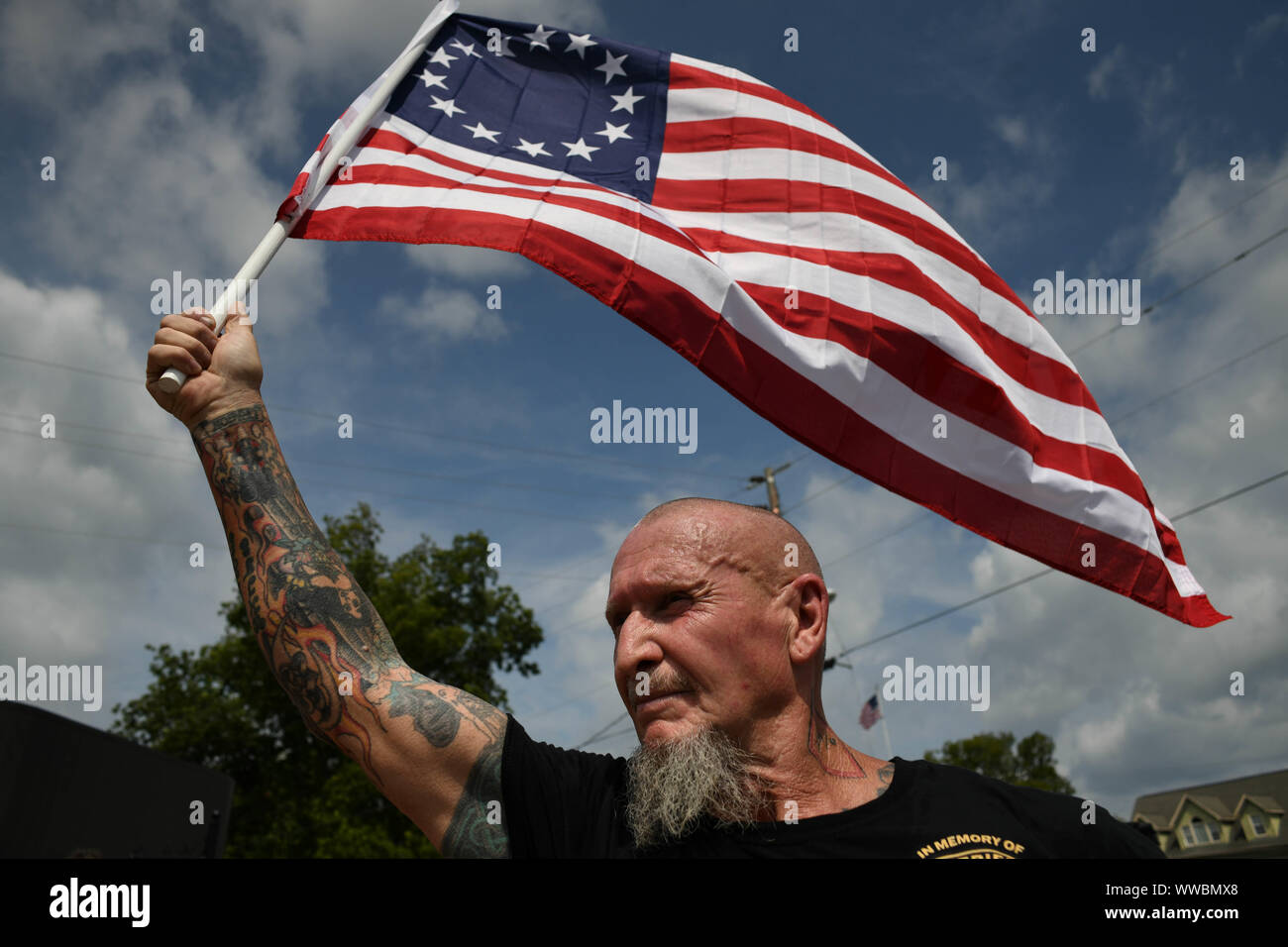 Dahlonega, Georgia, USA. 14th Sep, 2019. CHESTER DOLES, a longtime white nationalist leader, leads a march of around 50 people in what he described as an 'American Patriot Rally'' to honor President Trump in Dahlonega, Georgia on Saturday. Doles said the event was 'not a so-called white nationalist rally'' and that 'anyone'' was welcome to attend and many of those who did bore swastika tattoos and other symbols of white supremacy. Hundreds of law enforcement officers outnumbered the rally participants and counter protesters. Credit: Miguel Juarez Lugo/ZUMA Wire/Alamy Live News Stock Photo