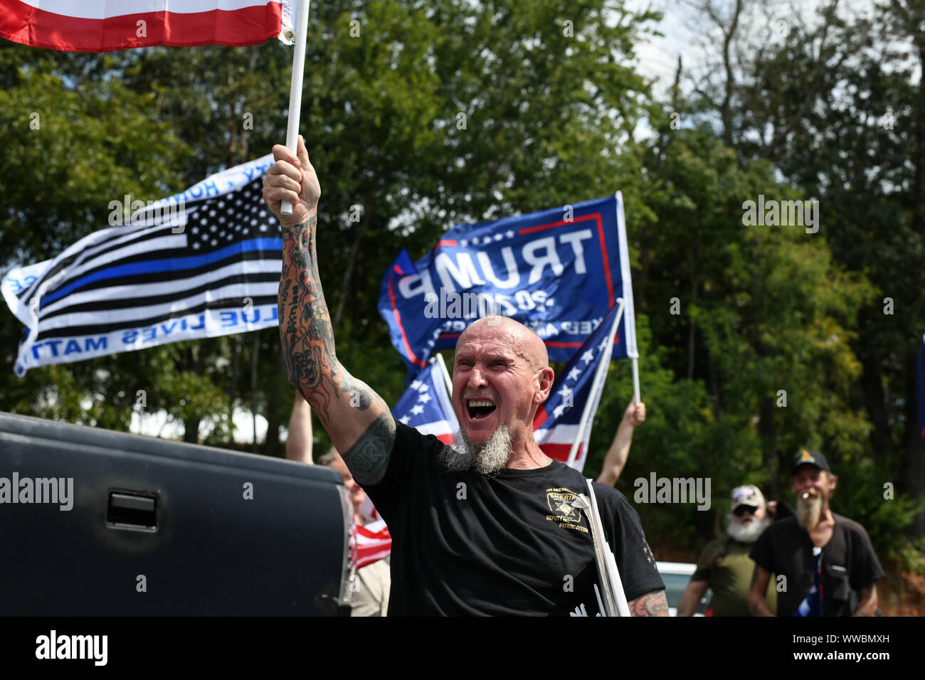 Dahlonega, Georgia, USA. 14th Sep, 2019. CHESTER DOLES, a longtime white nationalist leader, leads followers in chants of "America is great,"" as he begins what he described as an "American Patriot Rally"" to honor President Trump in Dahlonega, Georgia on Saturday. All told, around 50 people joined Doles' rally, while around 100 people joined counter-protests at the event, which drew 600 law enforcement officers from surrounding counties. Credit: Miguel Juarez Lugo/ZUMA Wire/Alamy Live News Stock Photo