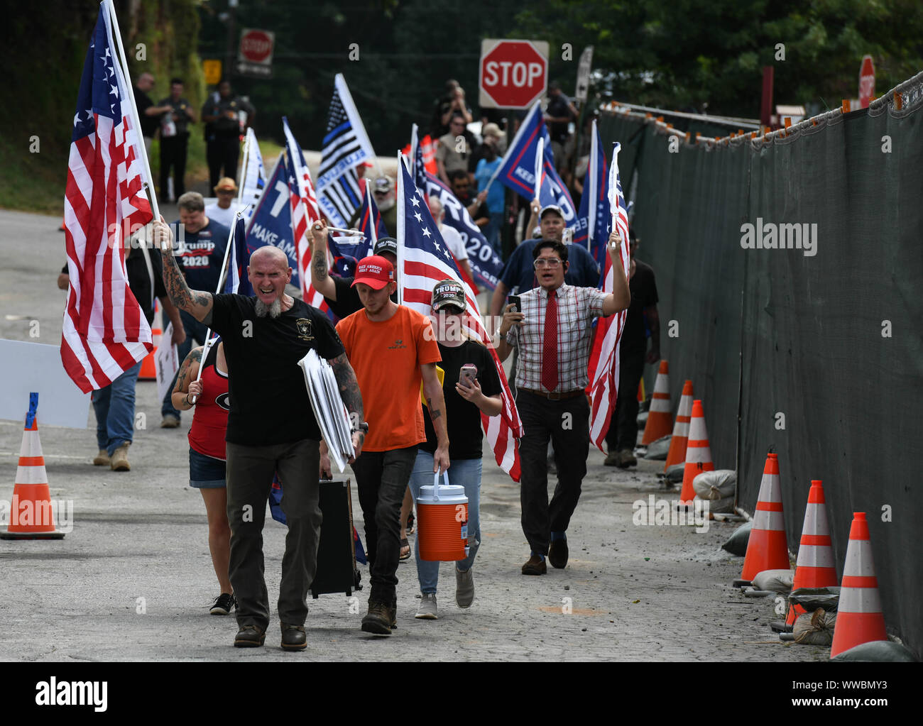 Dahlonega, Georgia, USA. 14th Sep, 2019. CHESTER DOLES, a longtime white nationalist leader, leads a march of around 50 people in what he described as an 'American Patriot Rally'' to honor President Trump in Dahlonega, Georgia on Saturday. Doles said the event was 'not a so-called white nationalist rally'' and that 'anyone'' was welcome to attend and many of those who did bore swastika tattoos and other symbols of white supremacy. Hundreds of law enforcement officers outnumbered the rally participants and counter protesters. Credit: Miguel Juarez Lugo/ZUMA Wire/Alamy Live News Stock Photo