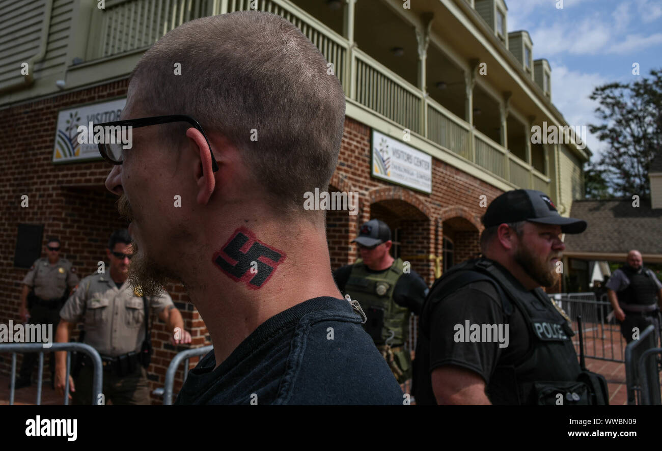 Dahlonega, Georgia, USA. 14th Sep, 2019. Tennessee resident KYNAN DUTTON, who once moved to North Dakota to build an all-white enclave there, watches a rally organized by longtime white nationalist leader Chester Doles in Dahonega, Georgia on Saturday. Doles billed the event, which drew around 50 supporters, as an 'American Patriot Rally'' to honor President Trump. Around 100 counter-protesters including affiliates of the so-called 'Antifa'' movement showed up, as well as hundreds of law enforcement agents from surrounding counties as shops and restaurants in the small, north Georgia Stock Photo