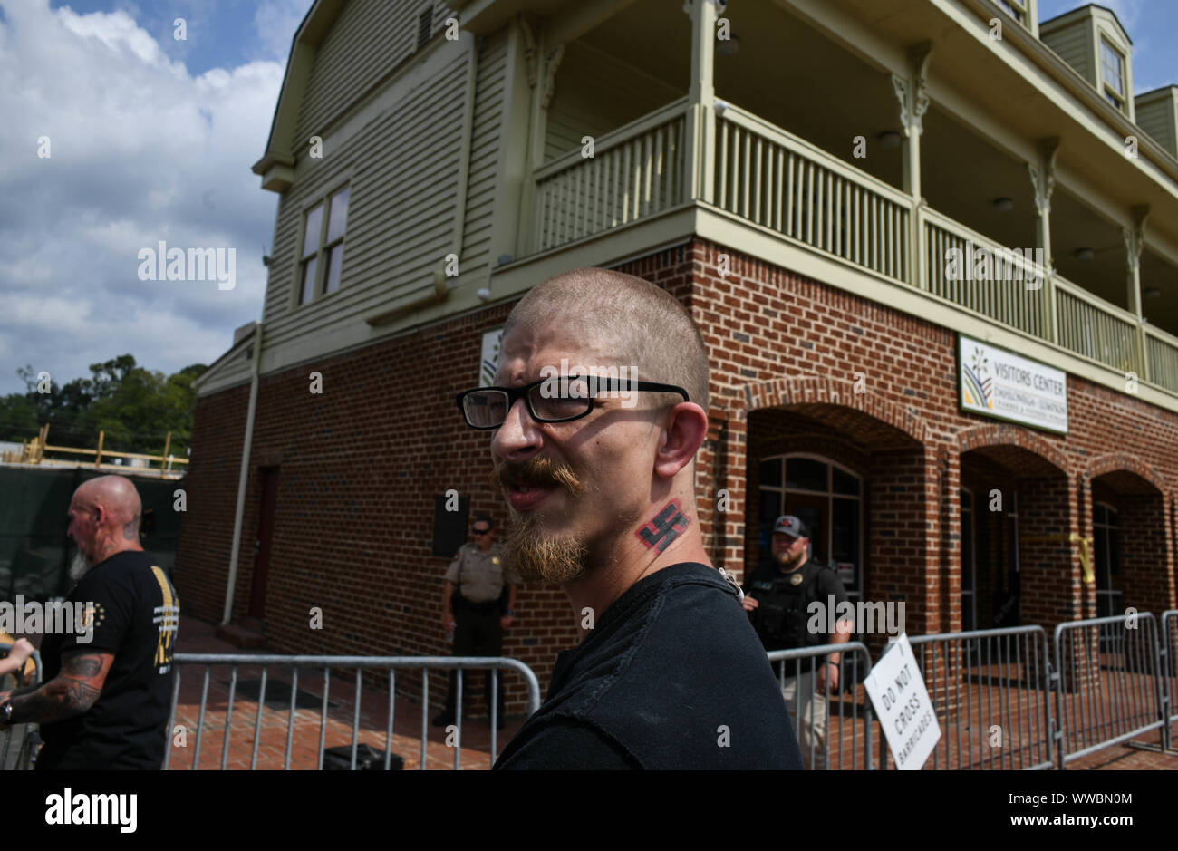 Dahlonega, Georgia, USA. 14th Sep, 2019. Tennessee resident KYNAN DUTTON, who once moved to North Dakota to build an all-white enclave there, watches a rally organized by longtime white nationalist leader Chester Doles in Dahonega, Georgia on Saturday. Doles billed the event, which drew around 50 supporters, as an "American Patriot Rally"" to honor President Trump. Around 100 counter-protesters including affiliates of the so-called "Antifa"" movement showed up, as well as hundreds of law enforcement agents from surrounding counties as shops and restaurants in the small, north Georgia Stock Photo