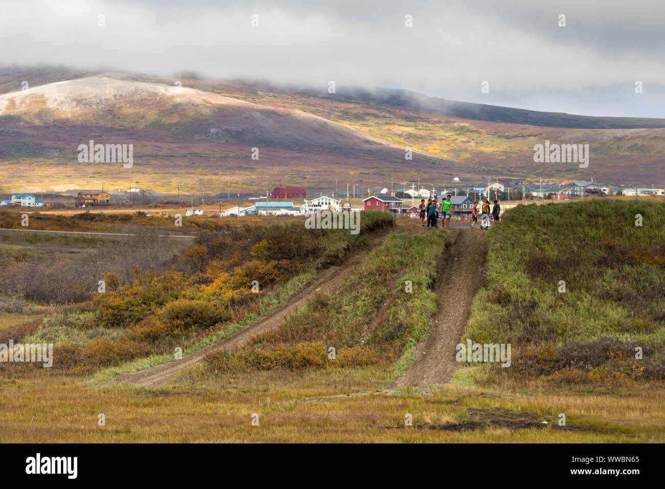 Local kids playing on a dirt road in Nome, Alaska. Stock Photo