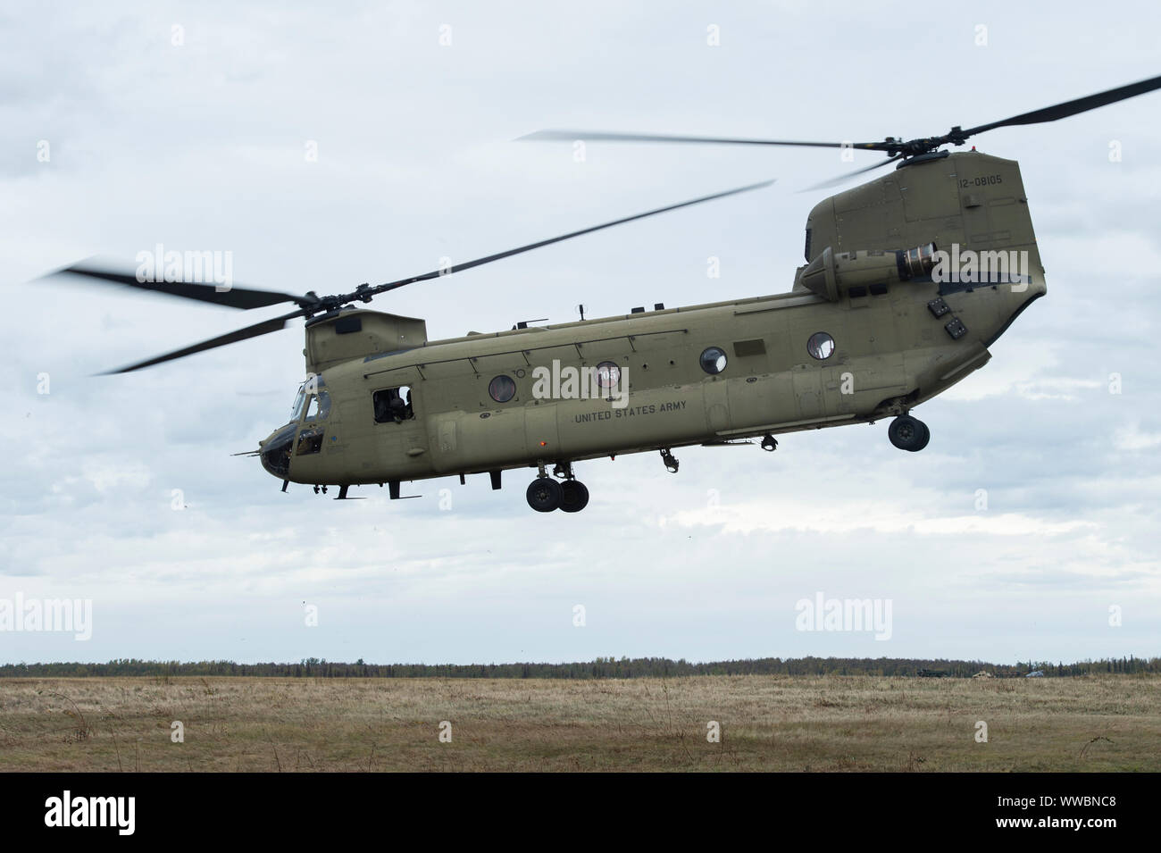 Army aviators with 1st Battalion, 52nd Aviation Regiment, out of Fort Wainwright, Alaska, take off in a CH-47 Chinook helicopter at Malemute Drop Zone during Army Pathfinder qualification at Joint Base Elmendorf-Richardson, Alaska, Sept. 12, 2019. The U.S. Army Pathfinder School provided the Alaska Soldiers a three week course in which the students navigated dismounted, established and operated a day/night helicopter landing zone, a day/night Air Force Computed Air Release Point drop zone, Army drop zones, conducted sling load operations, and provided air traffic control as well as navigationa Stock Photo