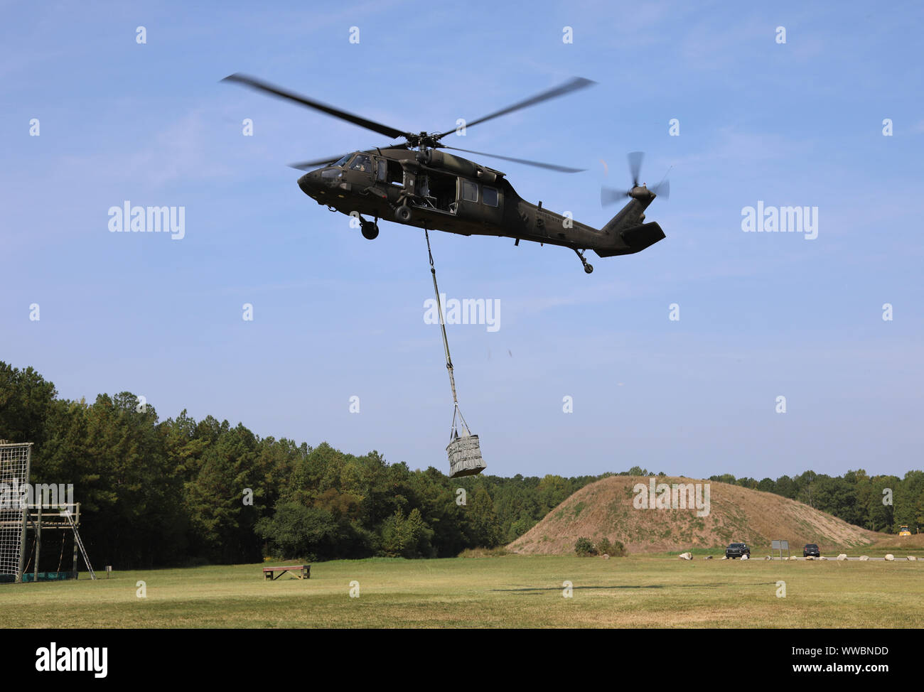 Virginia Army National Guard UH-60 Black Hawk sling loads an ammunition package Sept. 11 during the Army Ammunition Transfer Holding Point Team of the Year competition at Fort Pickett, Va. Teams prepared munitions for transport by configuring, inspecting, and ensuring the safety and compatibility of loads. ATHP started Sept. 9 and ran through Sept. 13. Teams of five Soldiers, from 75th Ranger Regiment, 10th Mountain Division, and 1st Cavalry Division, were assessed on ATHP operations and associated tasks that facilitate the receipt and transfer of ammunition. Stock Photo