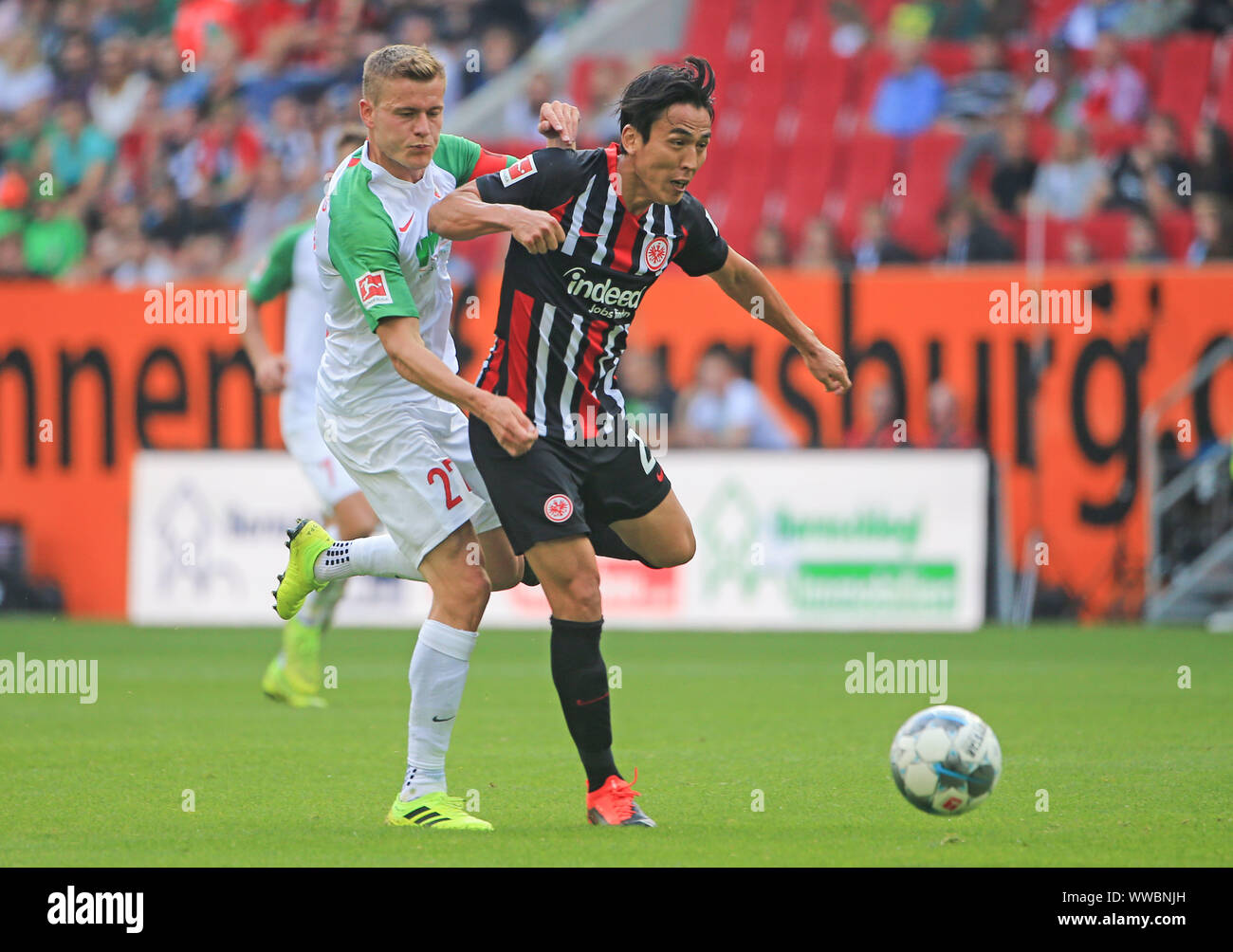 Augsburg, Germany. 14th Sep, 2019. Alfred Finnbogason (L) of Augsburg vies with Makoto Hasebe of Frankfurt during a German Bundesliga match between FC Augsburg and Eintracht Frankfurt in Augsburg, Germany, on Sept. 14, 2019. Credit: Philippe Ruiz/Xinhua Stock Photo