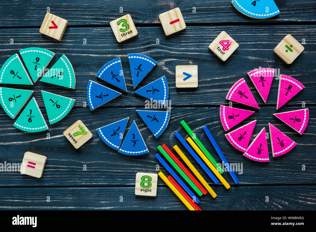 Colorful math fractions on wooden background or table. interesting math