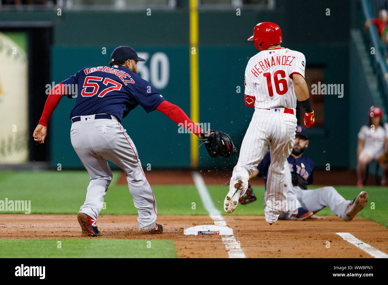 Philadelphia, Pennsylvania, USA. 14th Sep, 2019. Philadelphia Phillies second baseman Cesar Hernandez (16) moves away from the tag by Boston Red Sox starting pitcher Eduardo Rodriguez (57) during the MLB game between the Boston Red Sox and Philadelphia Phillies at Citizens Bank Park in Philadelphia, Pennsylvania. Christopher Szagola/CSM/Alamy Live News Stock Photo