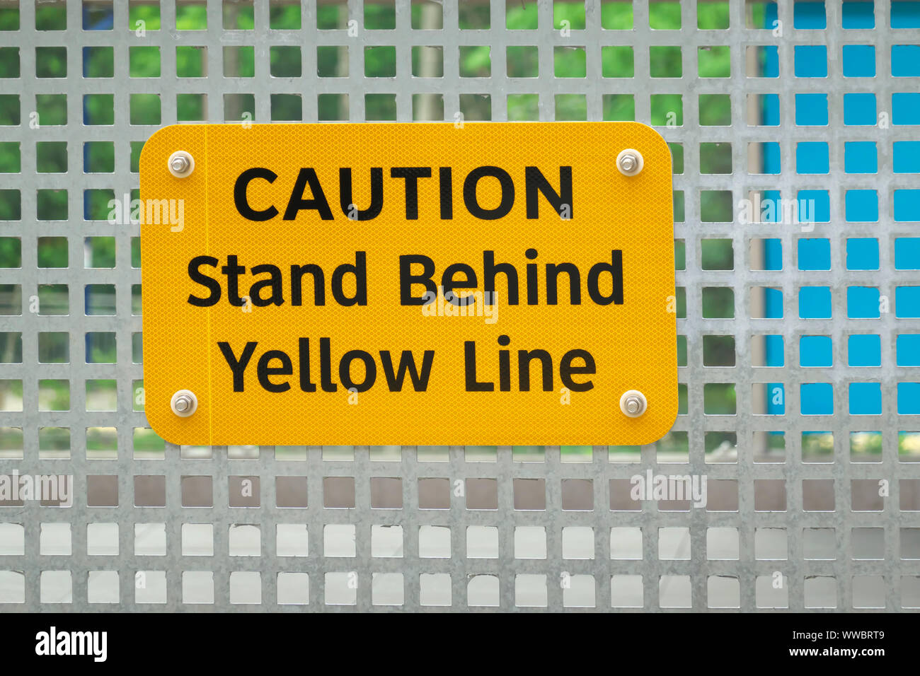 'CAUTION Stand Behind Yellow Line' Warning Sign Posted on Skytrain Platform, Vancouver, B. C., Canada Stock Photo