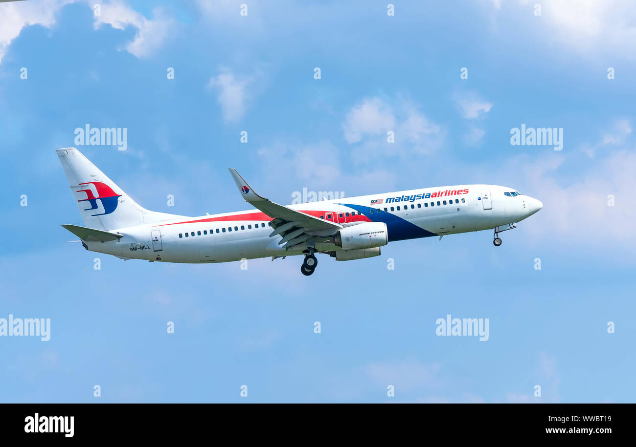 Airplane Boeing 737 of Malaysia Airlines flying through sky prepare to landing at Tan Son Nhat International Airport, Ho Chi Minh City, Vietnam Stock Photo