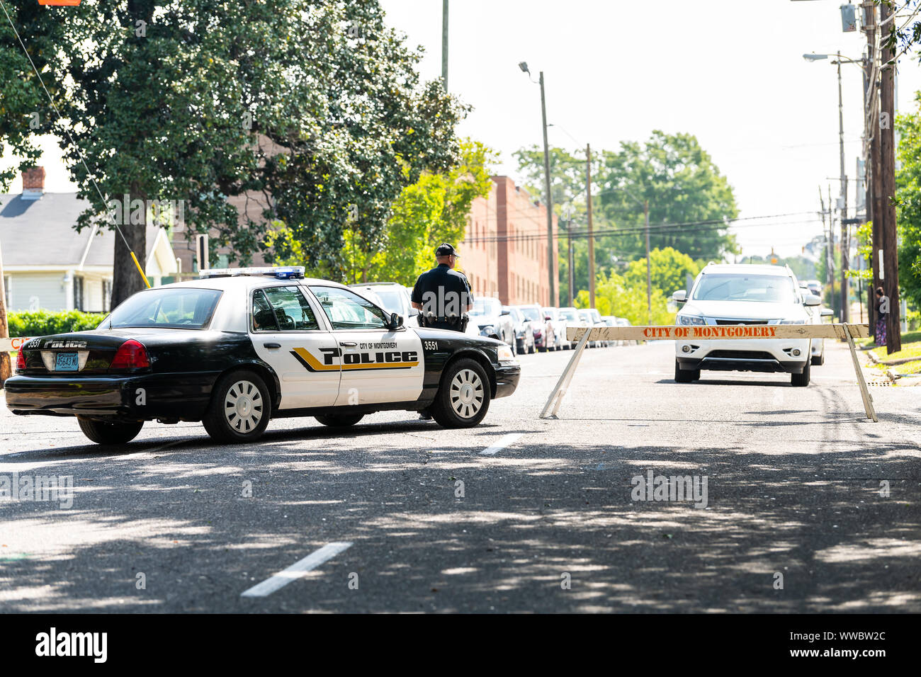 Montgomery, USA - April 21, 2018: Alabama city police officer or policeman car on street with sign on sidewalk with blocked road block or roadblock Stock Photo