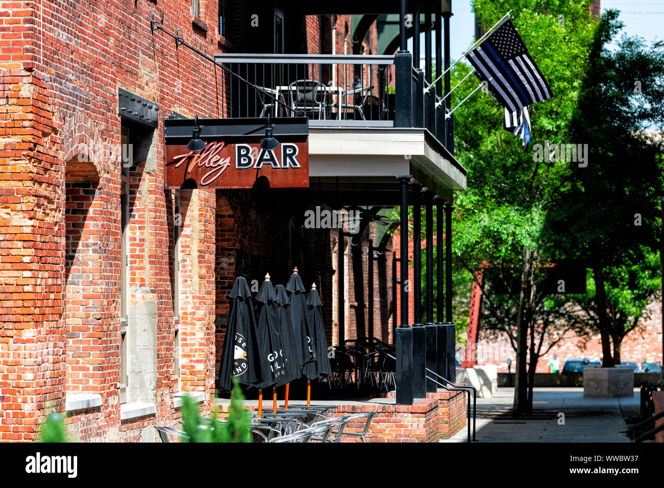 Montgomery, USA April 21, 2018 Brick buildings restaurant bar on Alley street during day in