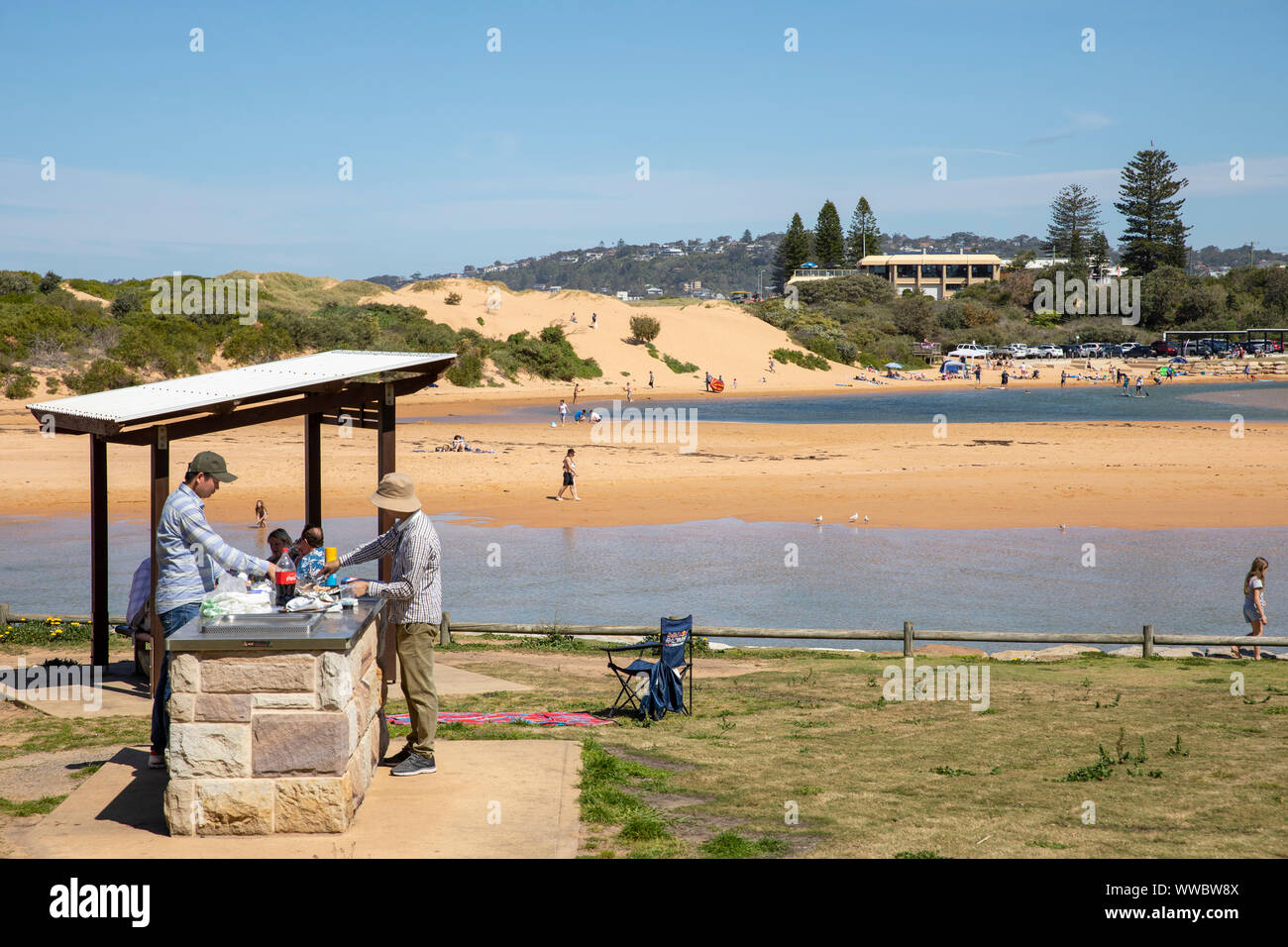 Two australian men cooking on a beach barbecue barbecue in Narrabeen on  Sydney northern beaches, New South Wales,Australia Stock Photo - Alamy