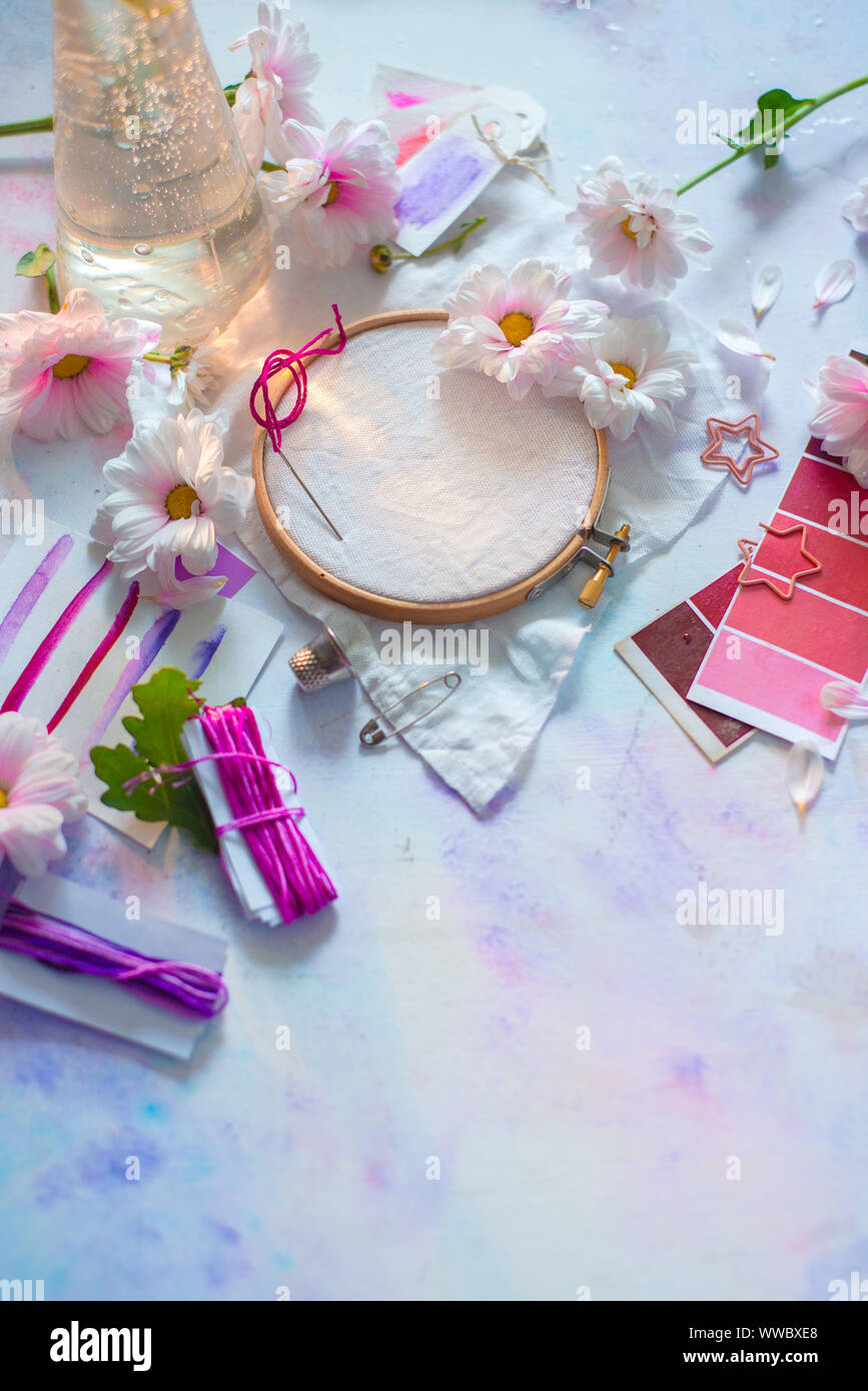 Embroidery frame close-up with flowers. Pink, white and purple pastel tones, copy space Stock Photo