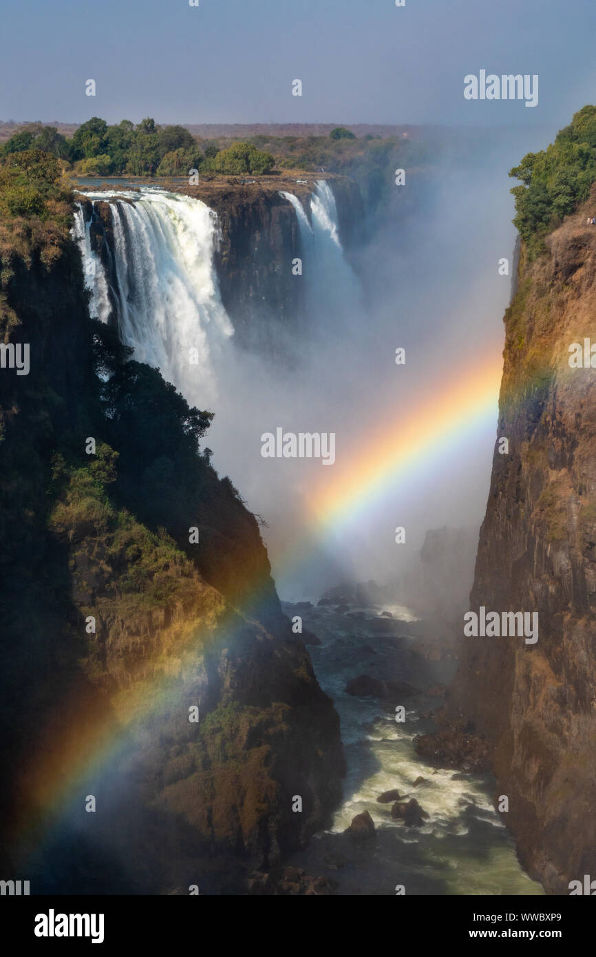 Victoria Falls and Gorge with Rainbow, Zambezi River, between Zimbabwe and Zambia, Africa Stock Photo