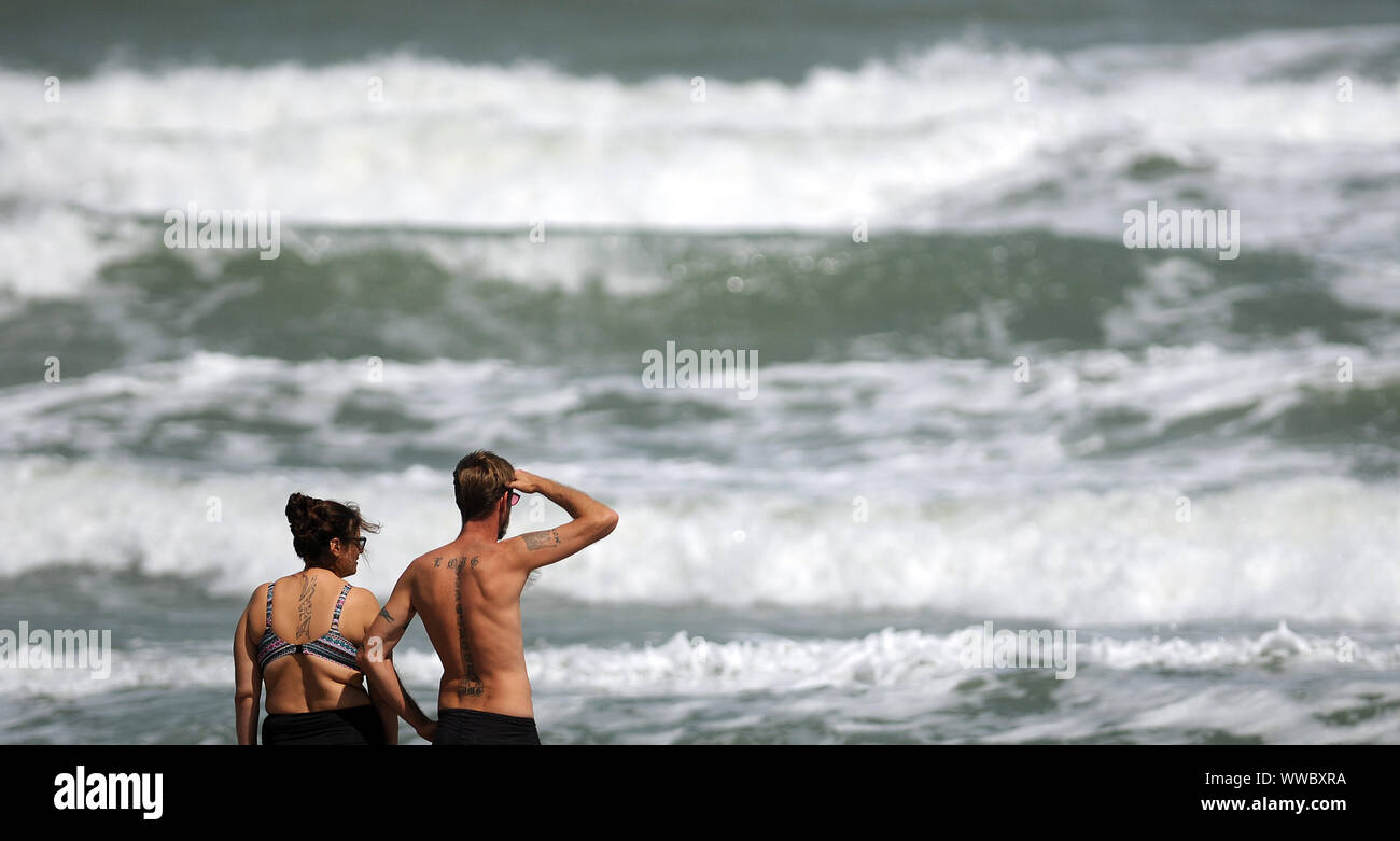 Florida, USA. 14th Sep, 2019. Beach-goers observe the rough surf generated by the Tropical Storm Humberto as it moves north off the coast of Florida. Credit: SOPA Images Limited/Alamy Live News Stock Photo