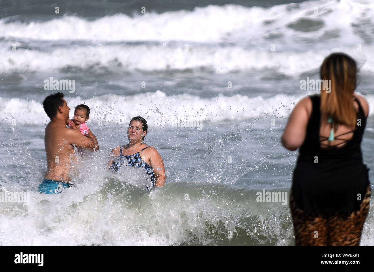 Florida, USA. 14th Sep, 2019. Beach-goers enjoy the rough surf generated by the Tropical Storm Humberto as it moves north off the coast of Florida. Credit: SOPA Images Limited/Alamy Live News Stock Photo