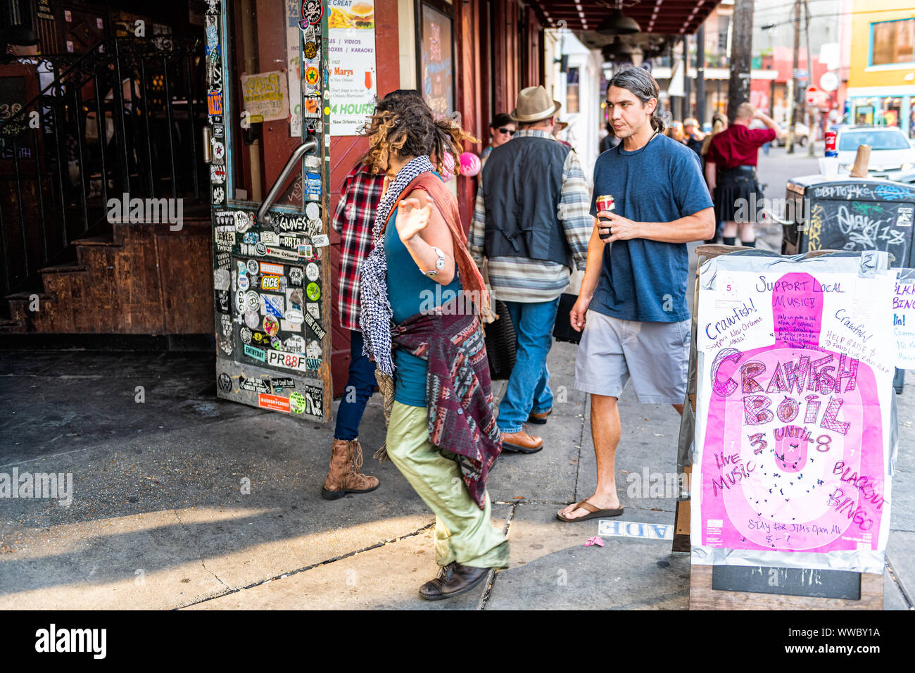 New Orleans, USA - April 22, 2018: People on French Quarter, Frenchmen street sidewalk of Louisiana old town city by entrance to Check Point Charlie M Stock Photo