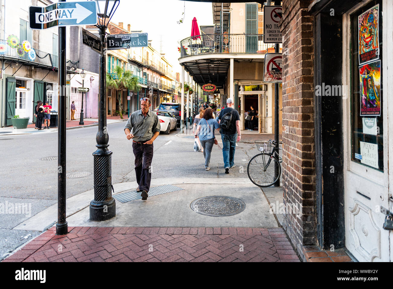 New Orleans, USA - April 22, 2018: French Quarter street covered sicewalk with people walking by restaurants, bars and music clubs at Louisiana old to Stock Photo