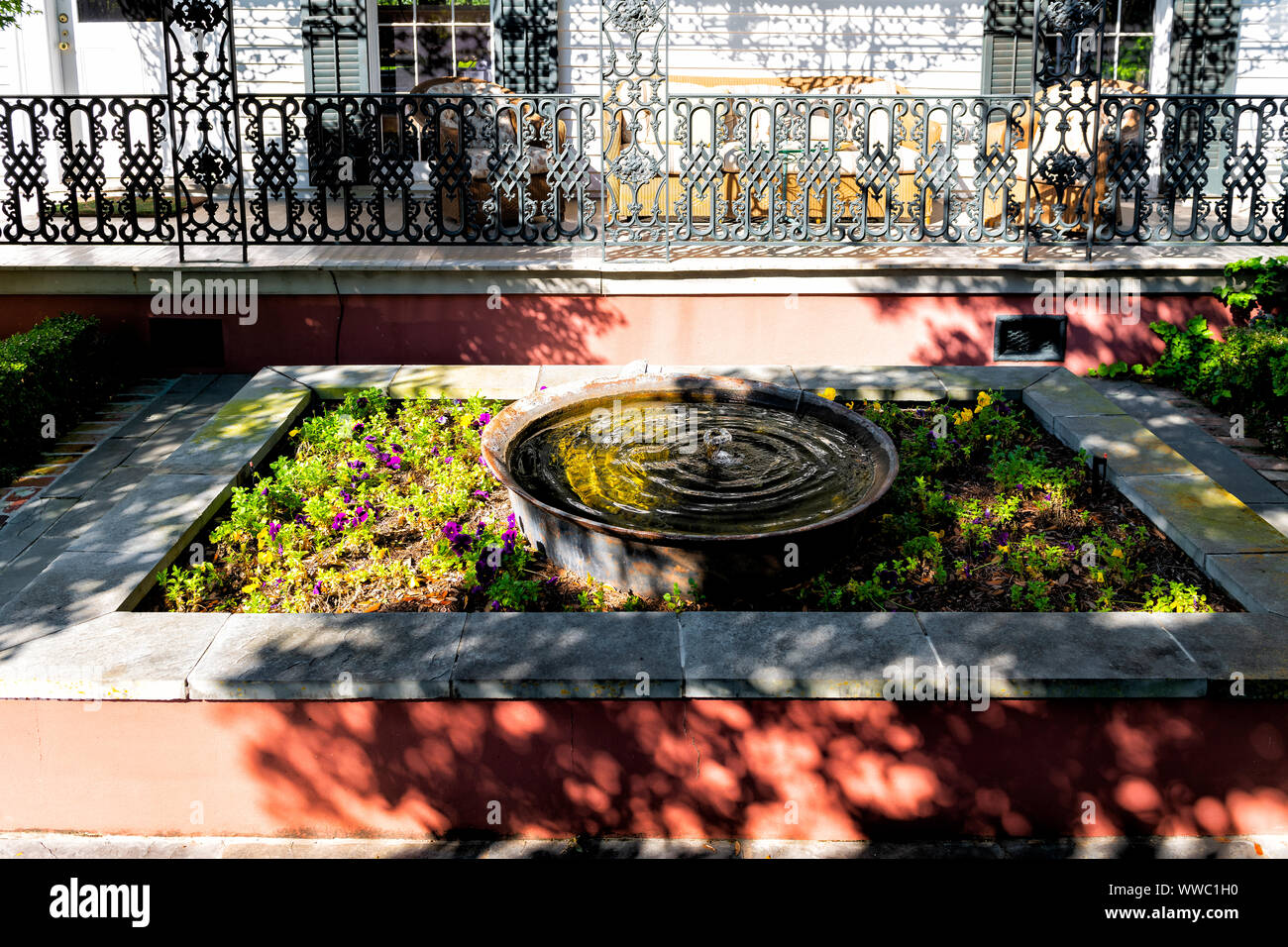 Old street historic Garden district in Louisiana city with garden water fountain by house patio or cast iron balcony in New Orleans, Louisiana Stock Photo