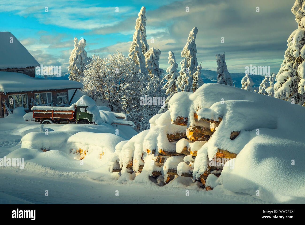 Winter and christmas landscape with snow covered scenery. Winter rural landscape with snow covered old car and wooden mountain hut. Christmas and Happ Stock Photo