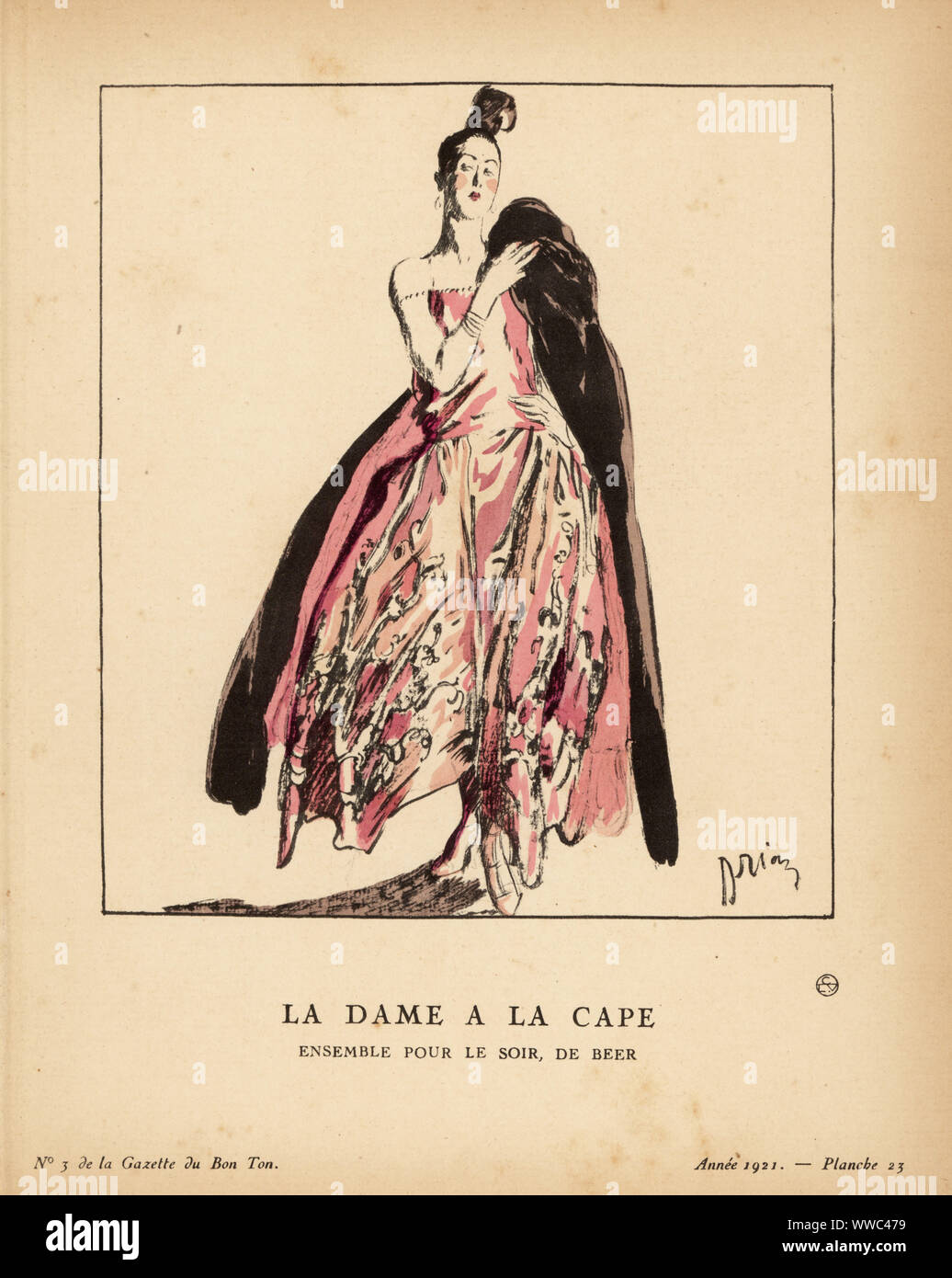 Woman in evening outfit of pink taffeta gown and black velvet cape. The cape is lined with pink ostrich feathers. La dame a la cape. Ensemble pour le soir de Beer. Voici, de Beer, un ensemble réunissant une robe du soir en taffetas rose brode argent formant des groupes de petites fleurs très en relief, et une cape en velours noir entièrement doublée de plumes d'autruche roses du même ton que la robe de taffetas. Handcoloured pochoir lithograph by Adrien Etienne Drian from Lucien Vogel’s Le Bon Genre: 100 Plates from Gazette du Bon Ton, Brentano’s, Paris, 1921. Stock Photo