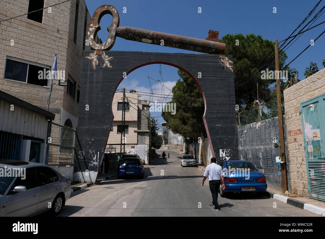 A huge, iron "key of return" rests over the entrance gate to Aida