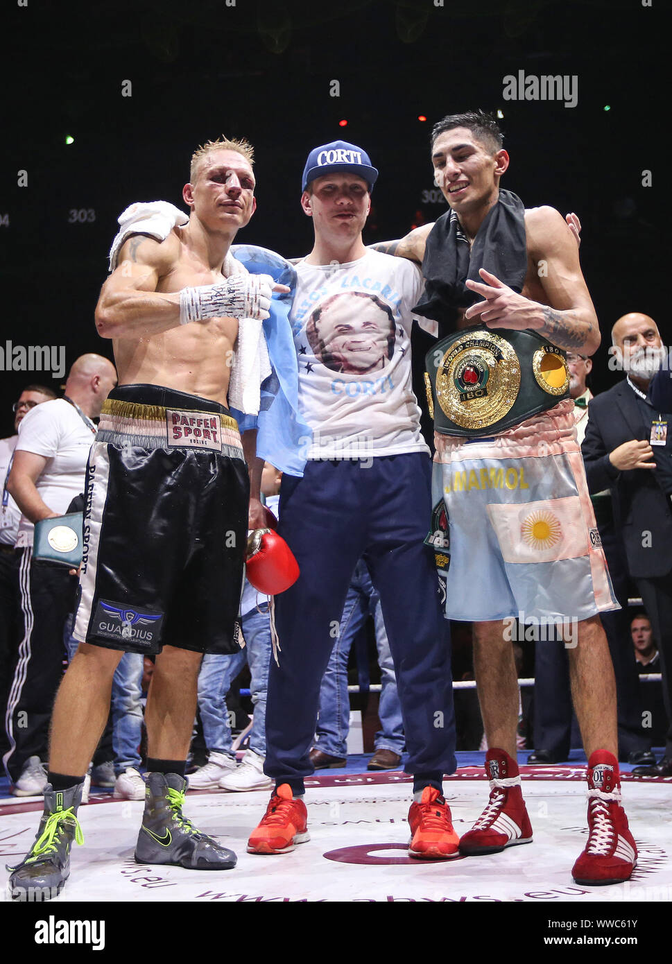 Chess boxers Arik Braun (R) and Felix Bartels sit in front of a chequer  board during the Chess Boxing Championships in Berlin, Germany, 28 July  2012. The chess boxing event took place