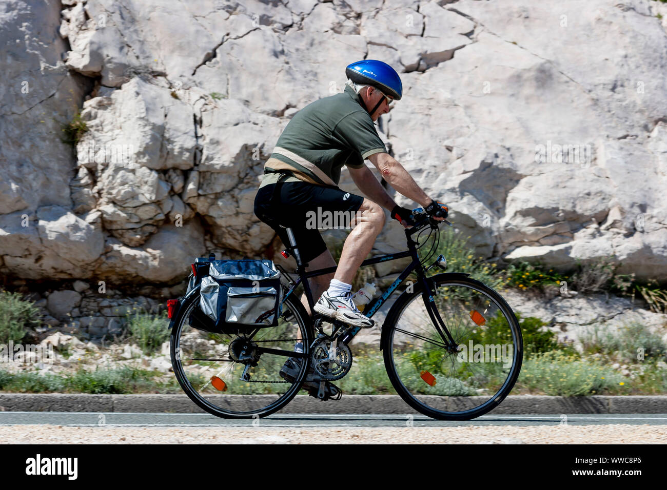 a bicyclist on mountain road driving Stock Photo