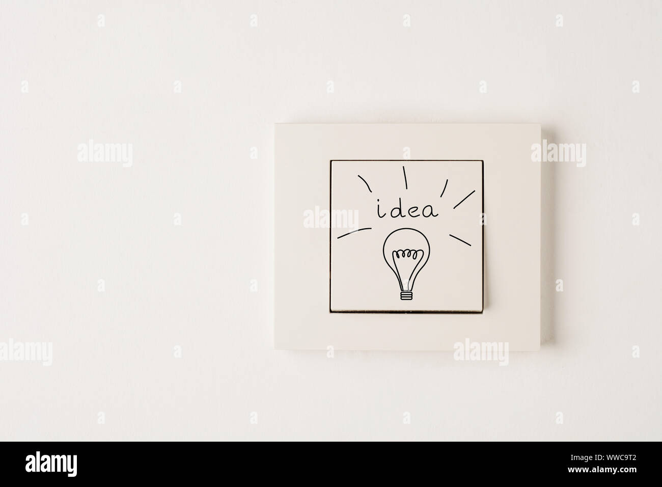 Creativity inspiration,ideas concepts with electric switch white wall background. Flat lay design. Stock Photo