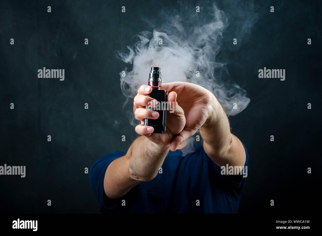 hand holding vape e-cigarette or electronic cigarette with white smoke over  a black background Stock Photo - Alamy