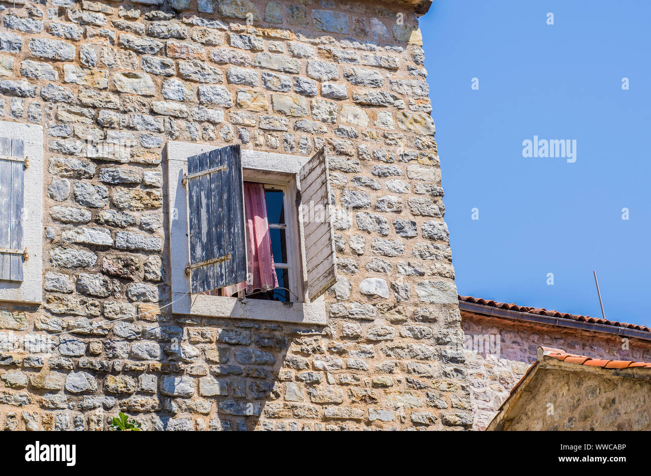 Stone wall with wooden shutters on the window Stock Photo - Alamy