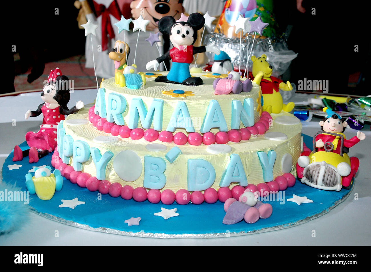 Colorful birthday cake decorated with little cartoon characters on the top  Stock Photo - Alamy