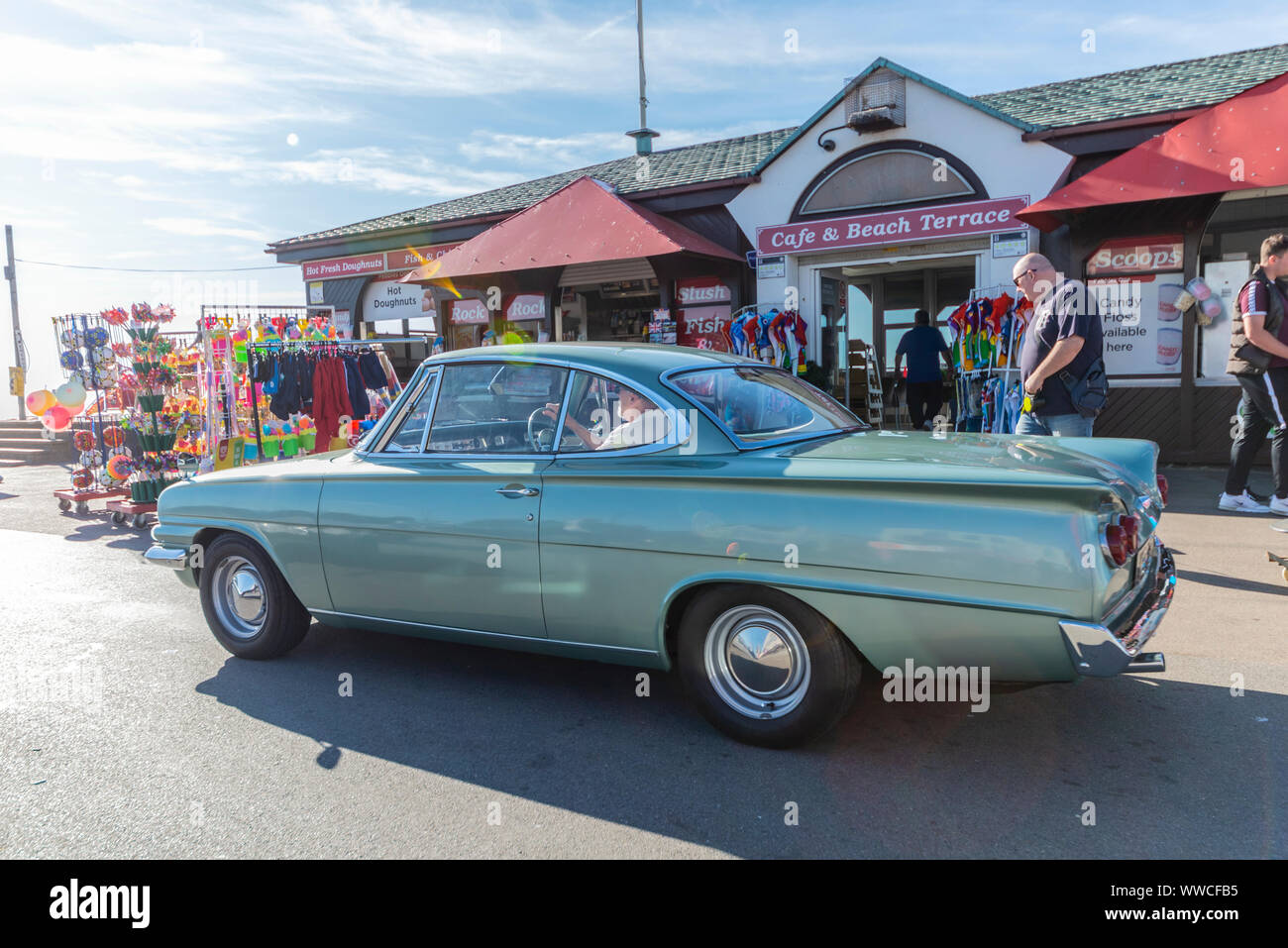 Classic and vintage cars have headed along the seafront of the seaside town to take part in a 'show 'n' shine' event at City Beach on Marine Parade in Southend on Sea, Essex. The UK weather has dawned bright, warm and sunny. Ford Consul Classic Capri Stock Photo