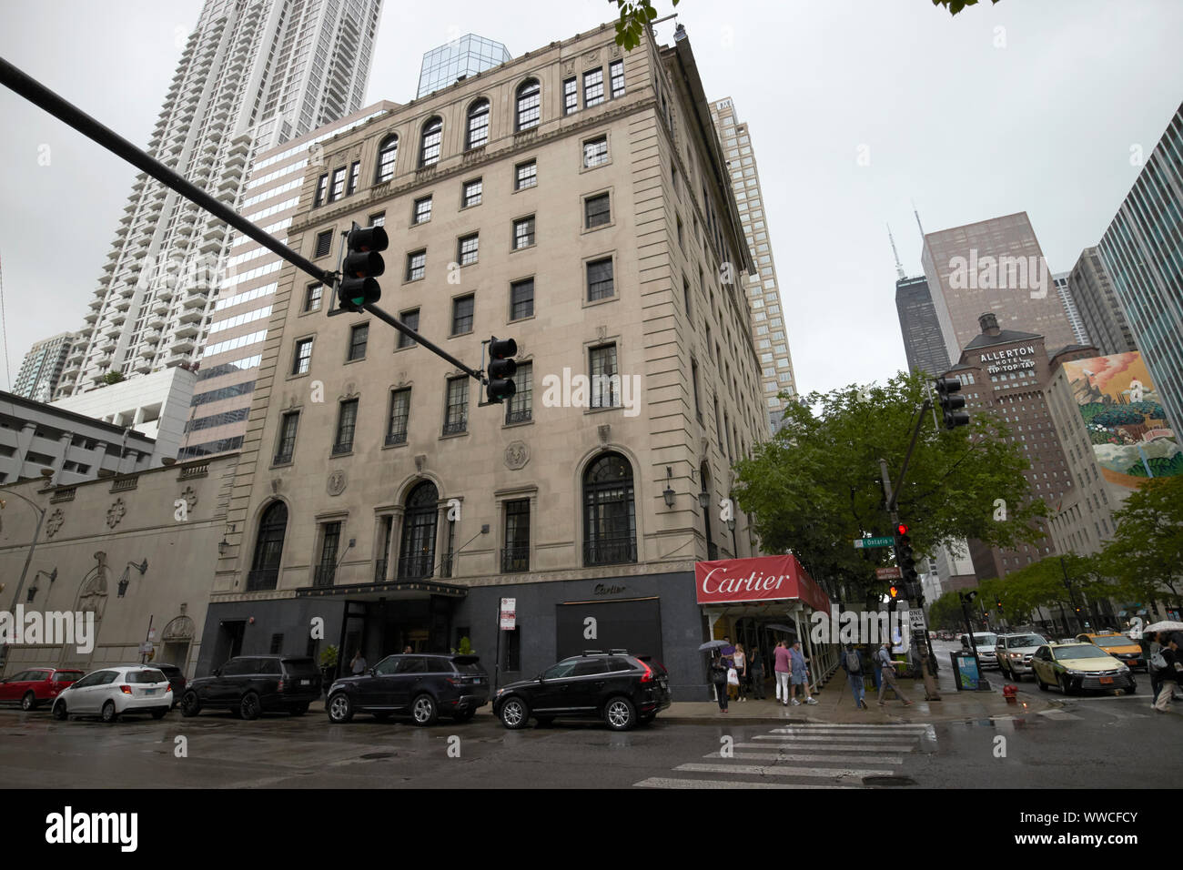 looking down north michigan avenue at the cartier store womans athletic club building magnificent mile on a wet overcast day in Chicago Illinois USA Stock Photo