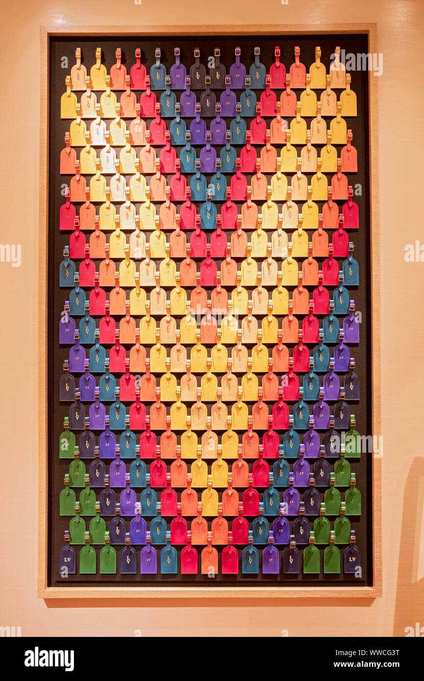 A very cleverly designed 'V' logo made out of different color luggage tags at the Vuitton store in Bloomingdale's in Manhattan, New York City. Stock Photo