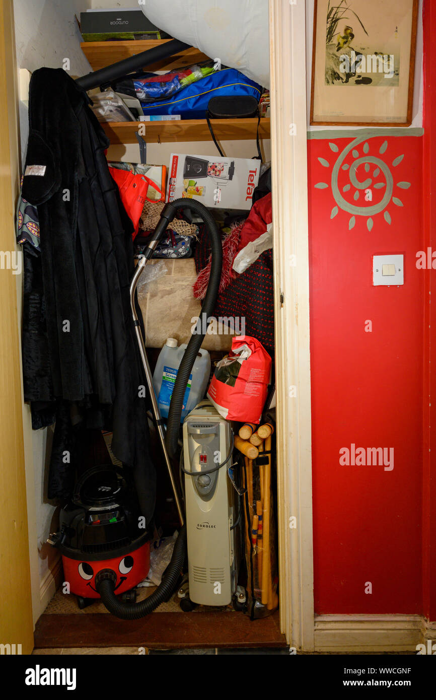 Clutter in cupboard Stock Photo