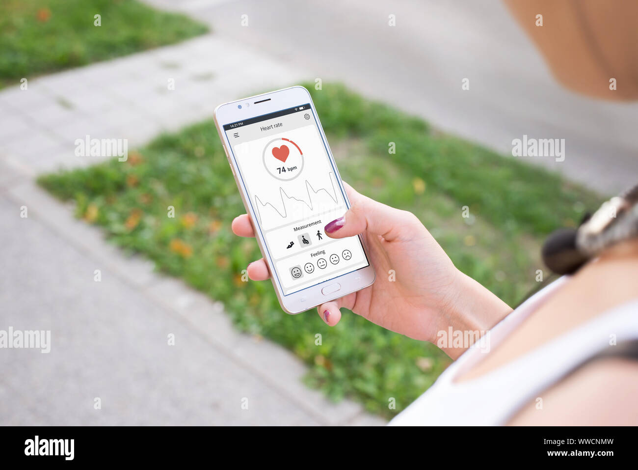 Girl use app and sensor on mobile phone to measure heart rate and SpO2. Stock Photo