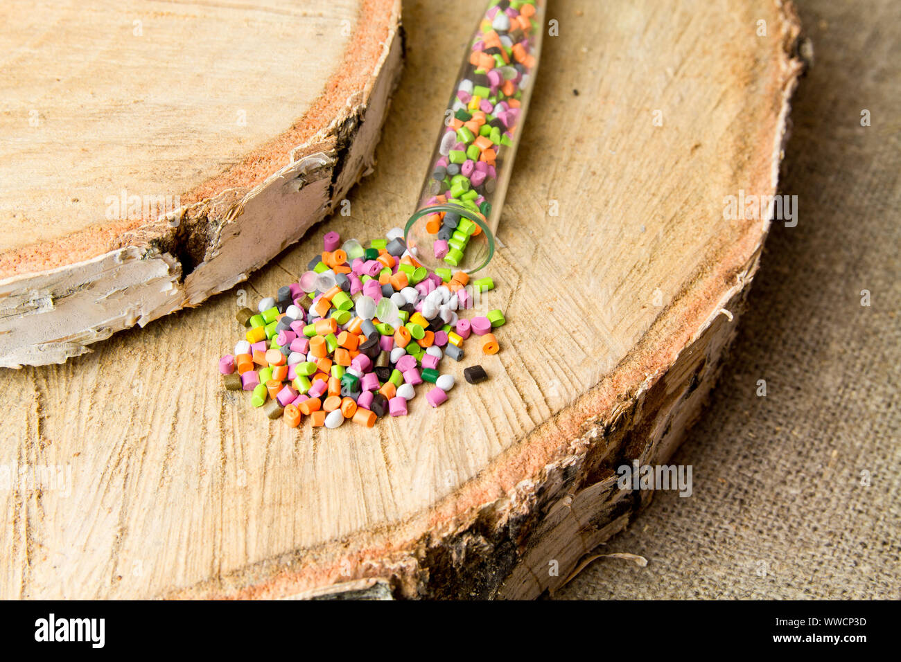 Plastic pellets .Polymeric dye in test tubes on gray background
