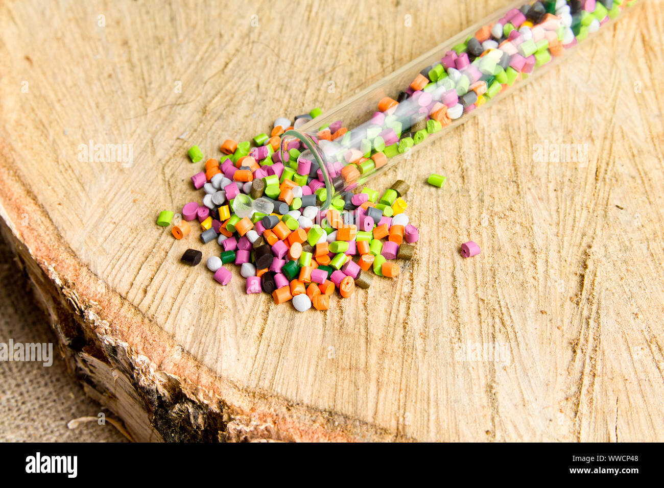 Plastic pellets .Polymeric dye in test tubes on gray background