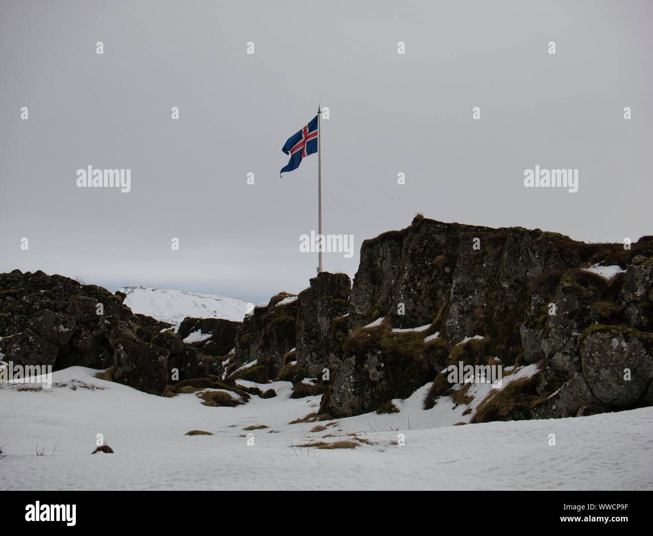 Icelandic flag at Law Rock in Iceland with snow in April Stock Photo