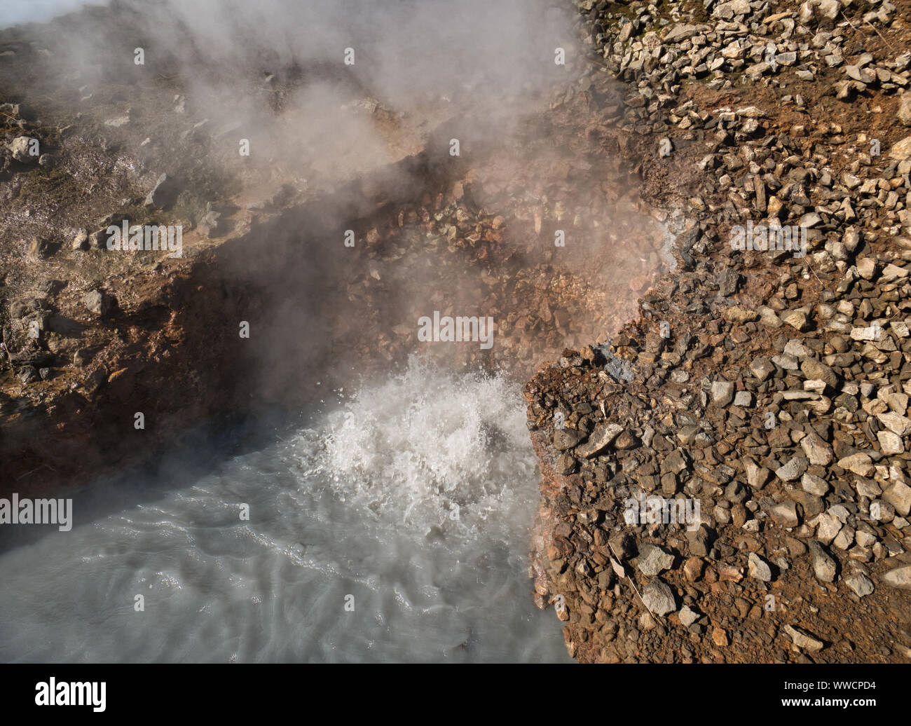 Steam over a boiling mud hole in Iceland with Reykjadalur Stock Photo