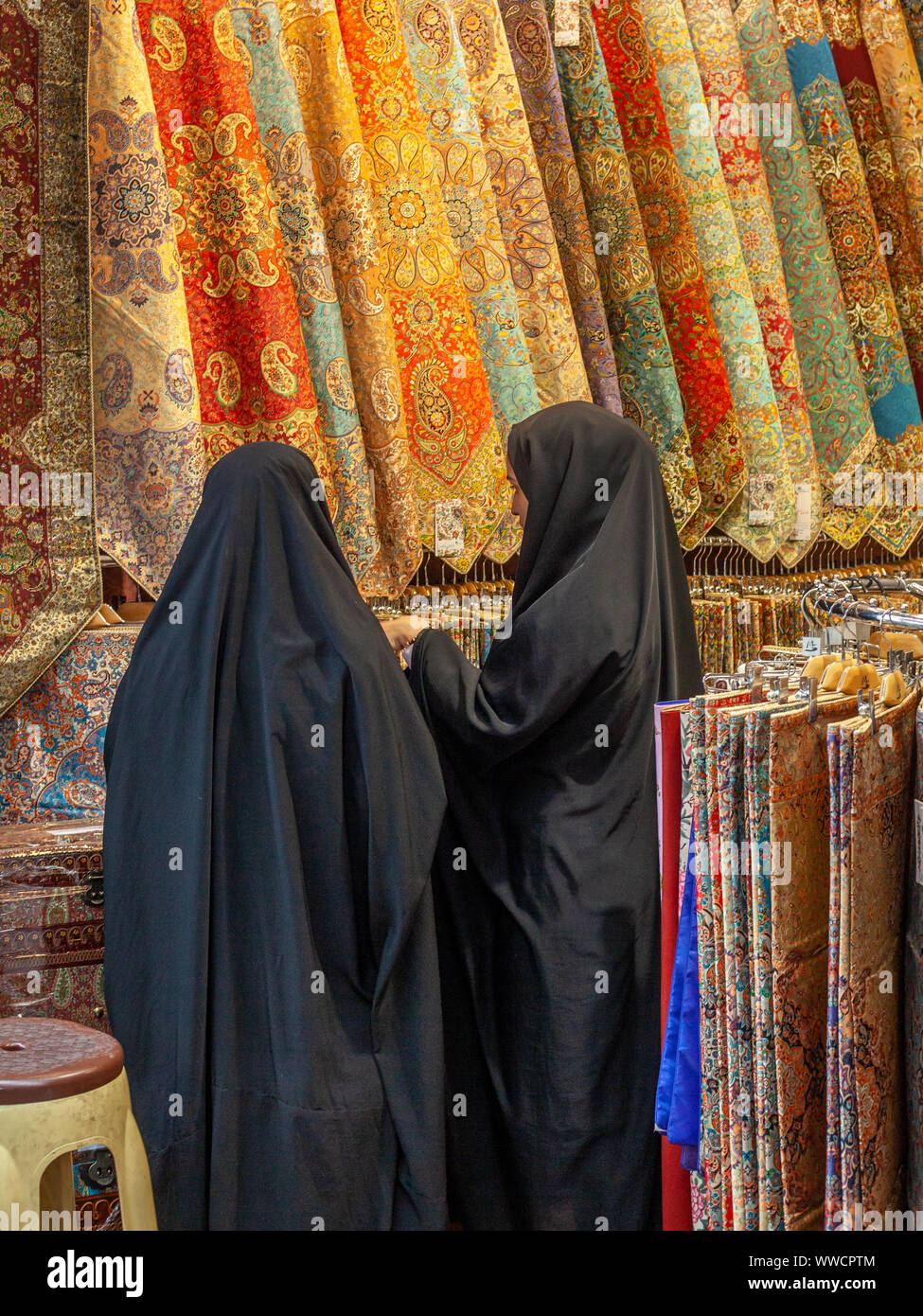 two muslim women buying tissues in a bazaar in Tehran, Iran Stock Photo