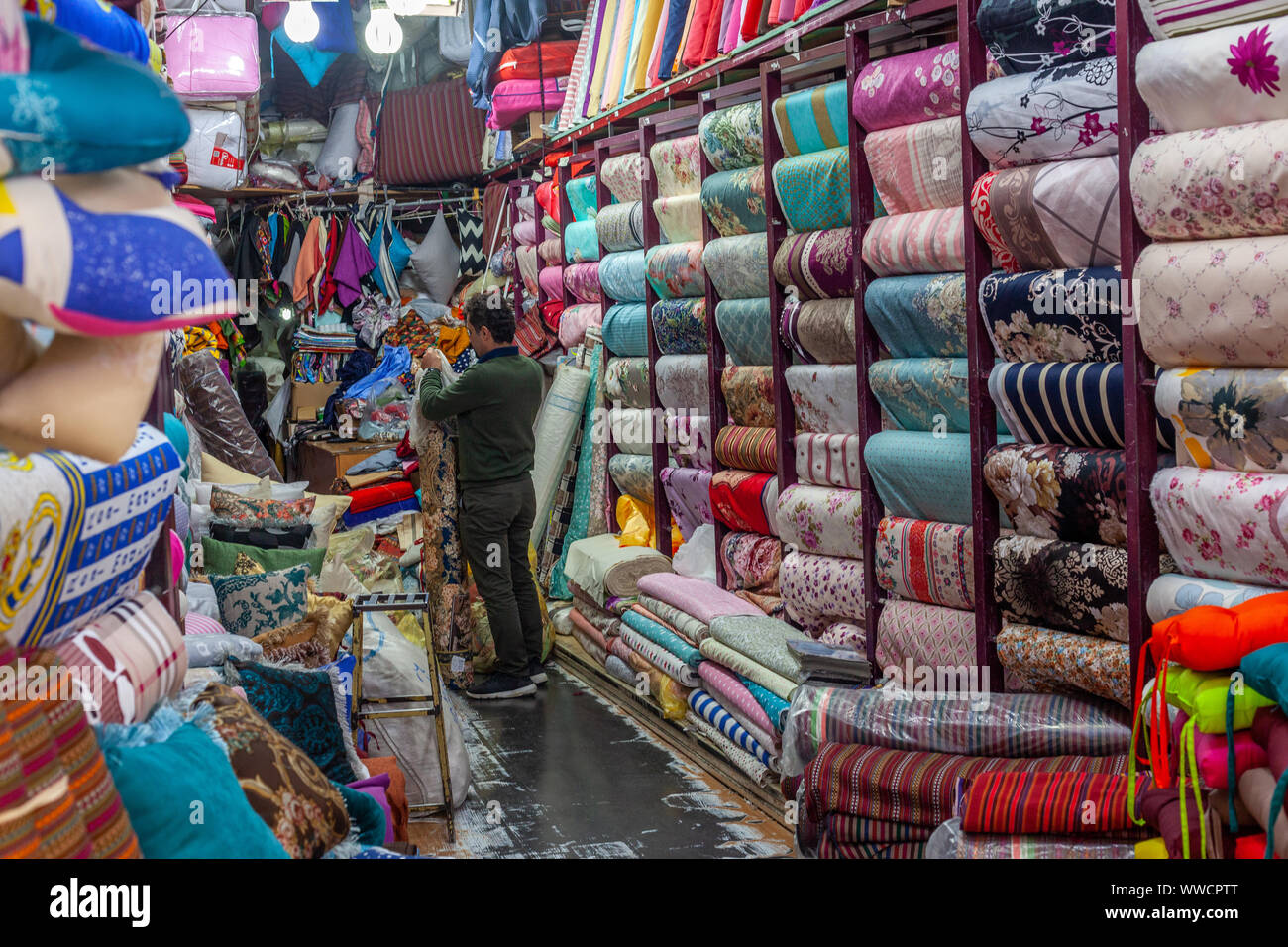 An Iranian man in his tissue shop on a Tehran bazaar. Stock Photo
