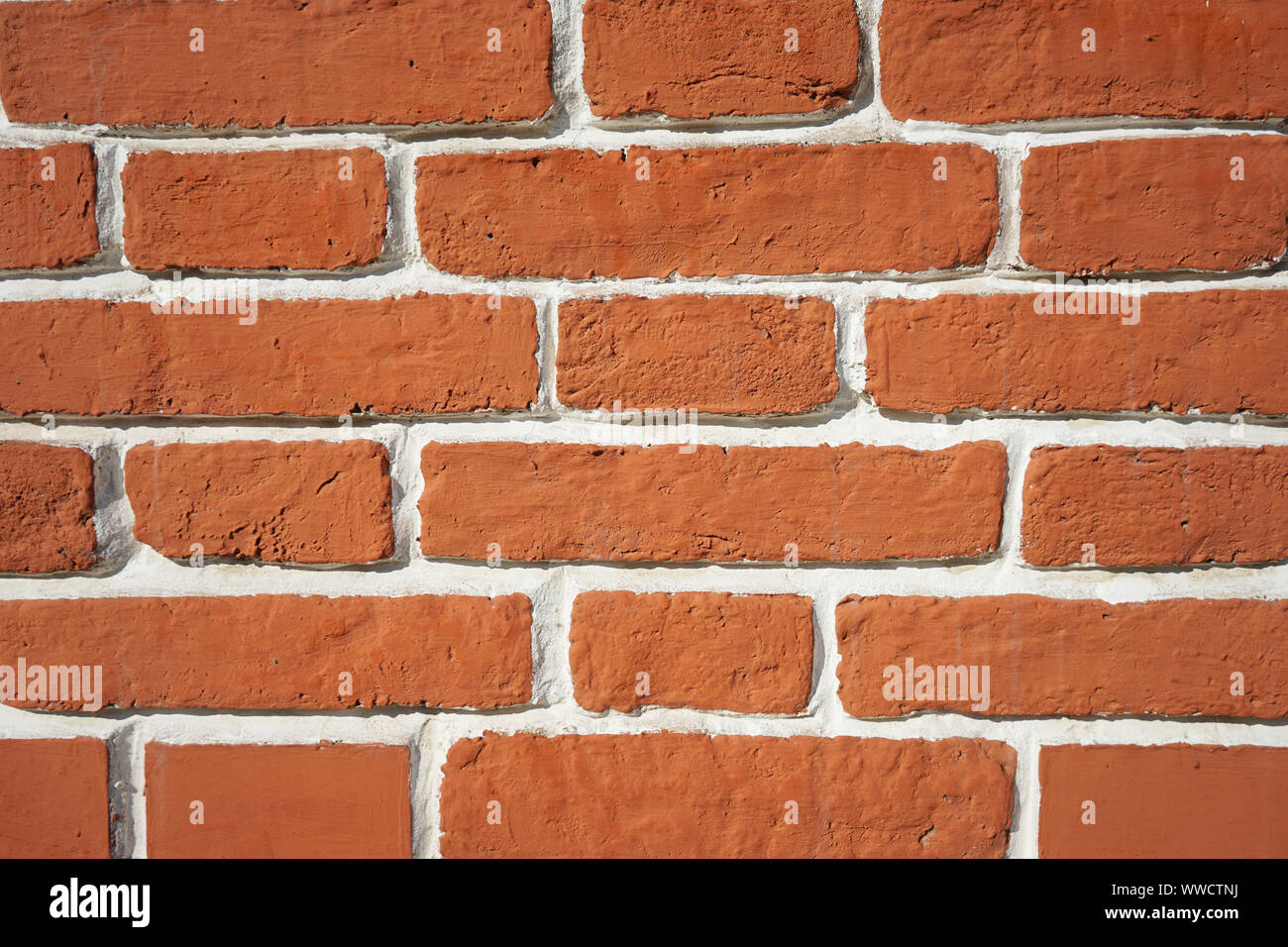 Background brick brown wall with white seams. Stock Photo