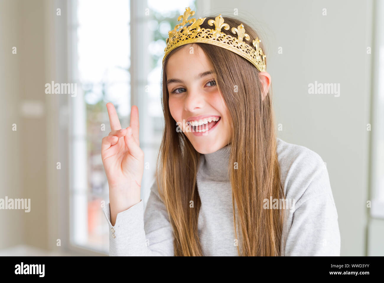 Beautiful young girl wearing a golden crown as a princess from ...