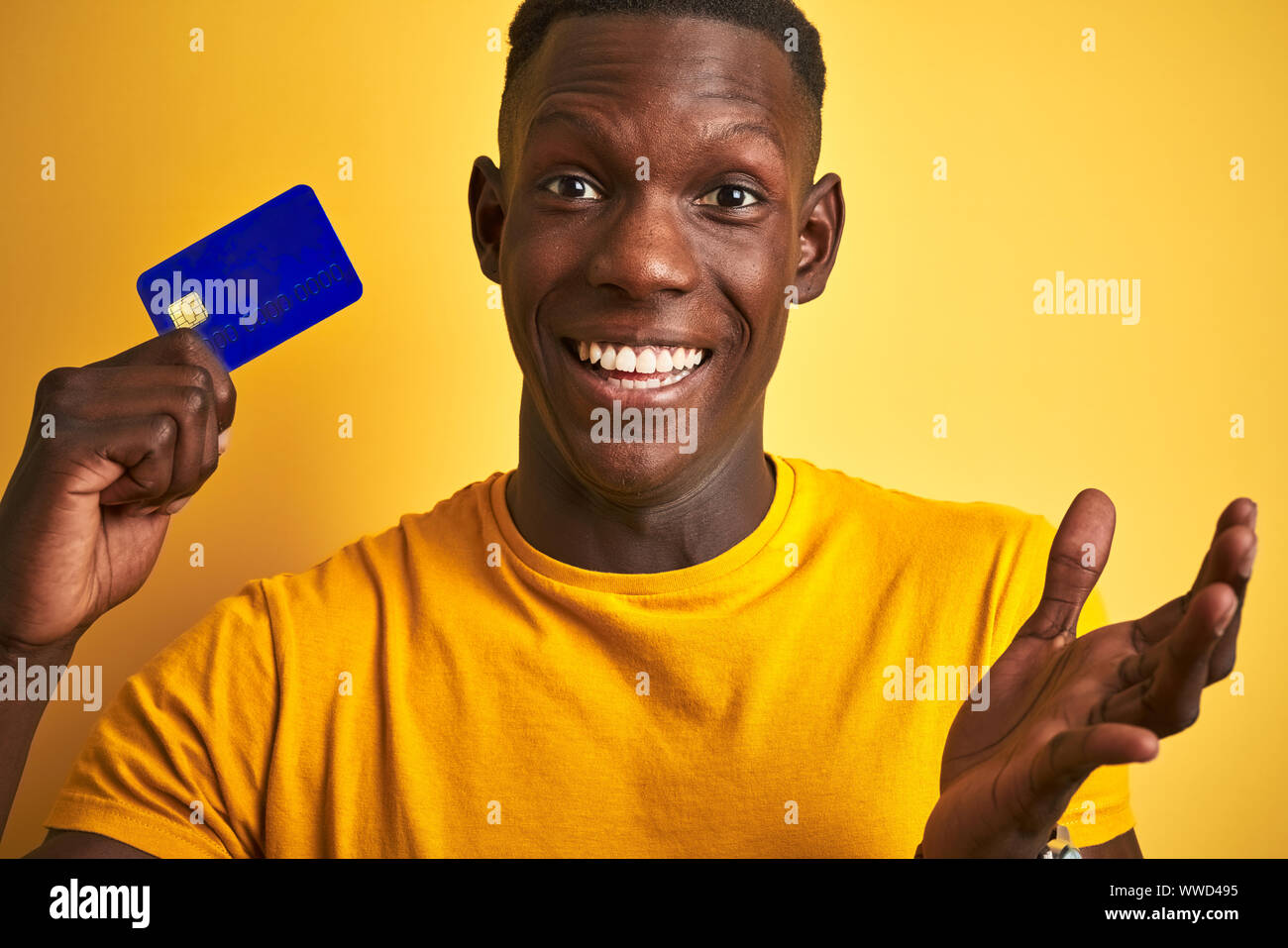 African american customer man holding credit card standing over ...