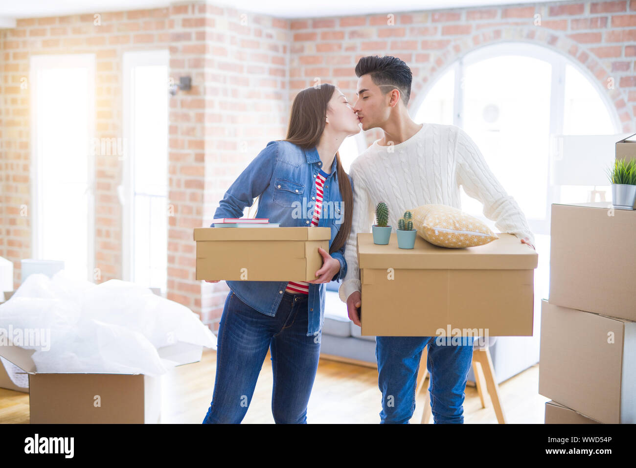 Beautiful young asian couple looking happy holding cardboard boxes ...